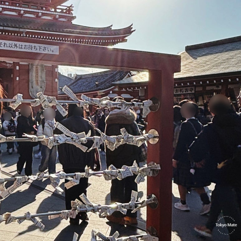Asakusa Sensoji omikuji bad fortune slips tied to metal rack