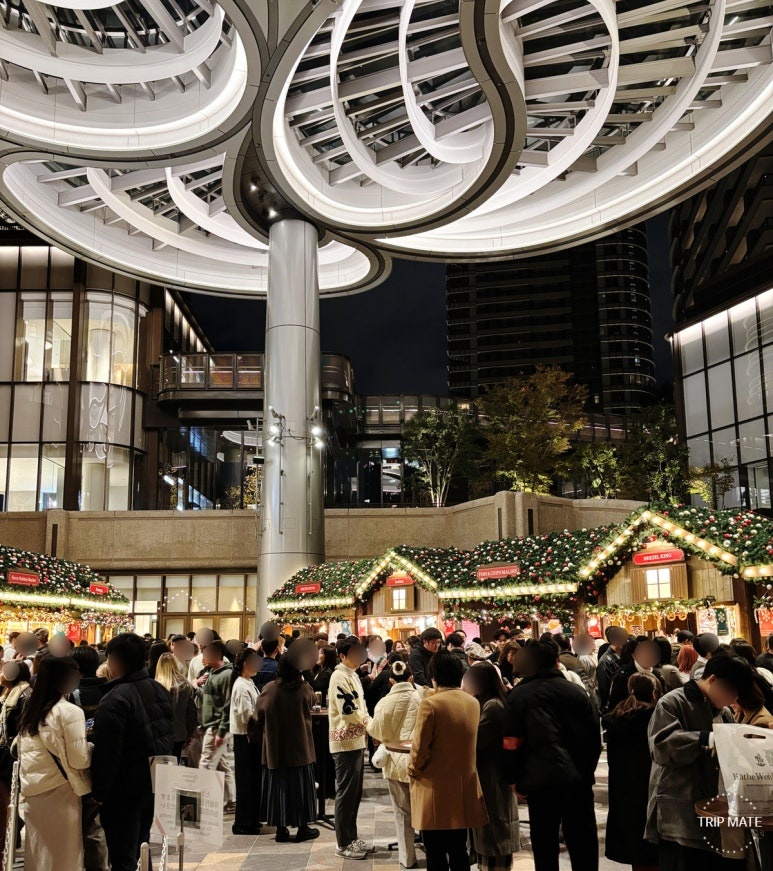 Azabudai Hills Christmas Market food booths with hot wine, sausages, pretzels, and fish & chips