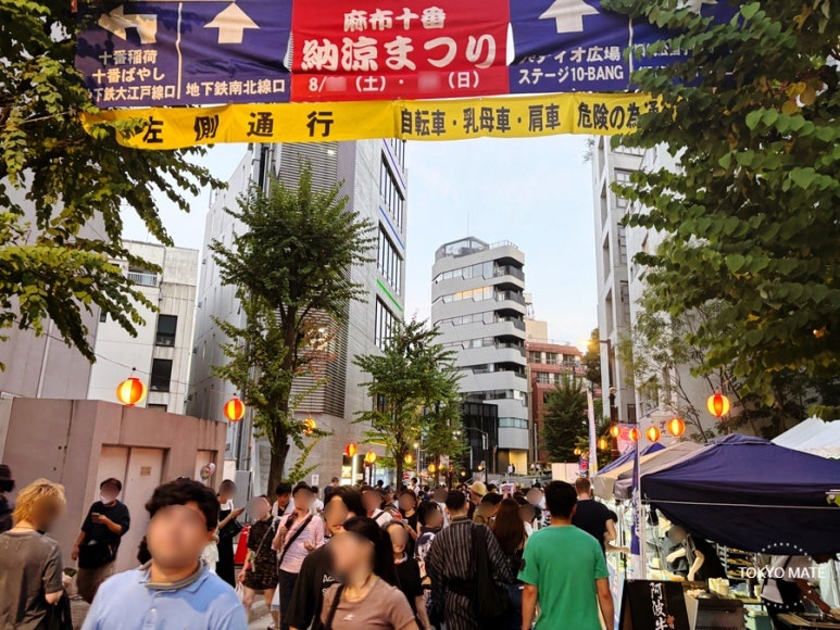 Crowds keeping left along the Azabujuban Noryo Festival shopping street