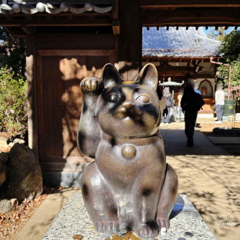 Gotokuji maneki-neko raising right paw without a koban coin, symbolizing beckoning good connections