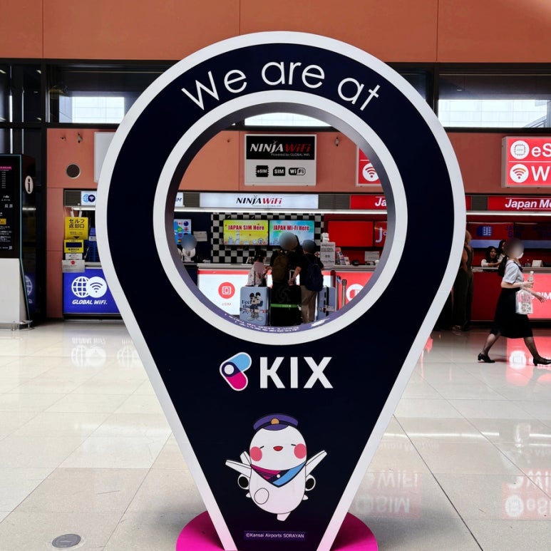 KIX pin sign in the Terminal 1 first-floor arrivals hall at Kansai Airport