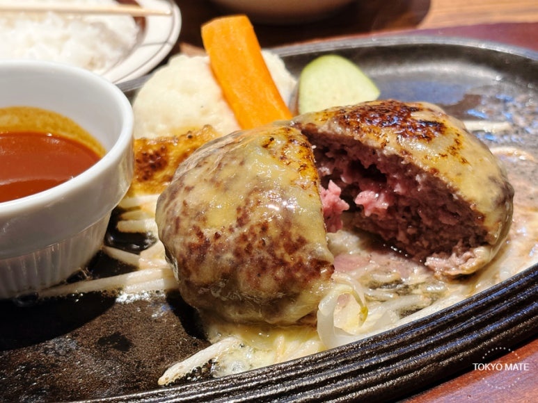 Meat Yazawa black wagyu hamburg steak with juices and a reddish center