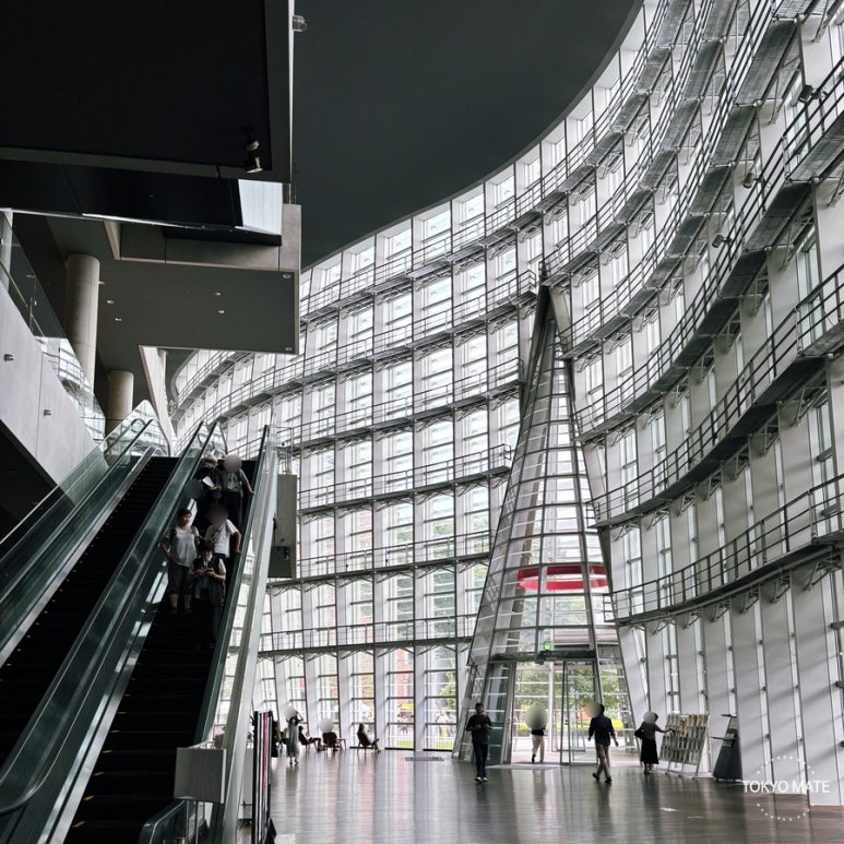 Interior of the National Art Center Tokyo with its wave-shaped glass curtain wall