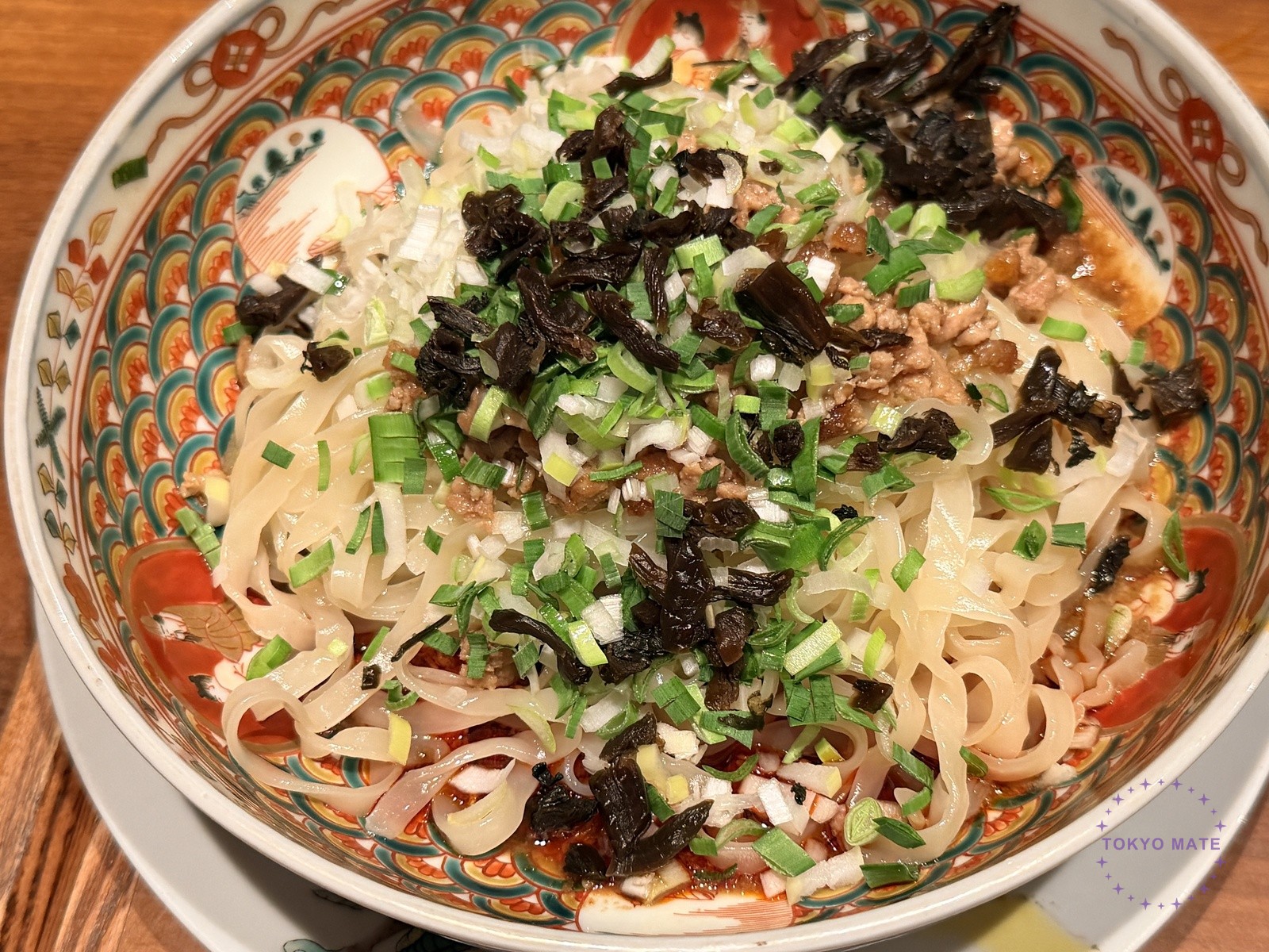 Dry dandan noodles with meat miso and chopped scallion on flat noodles