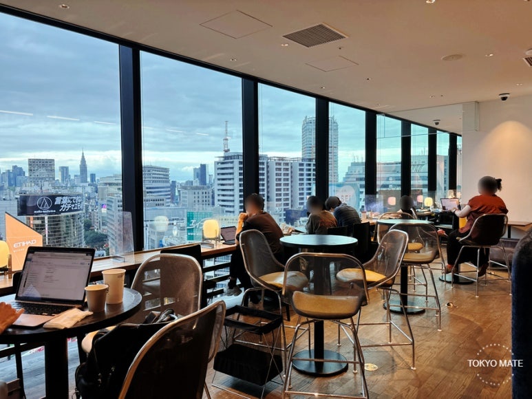 Window-facing seats and the view around Shibuya Station at the Shibuya Share Lounge