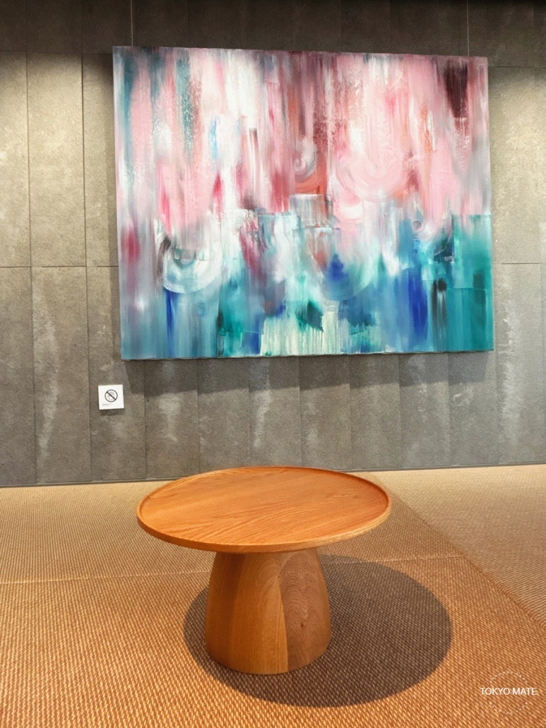 Second-floor exhibition space with contemporary artworks and tatami-style seating