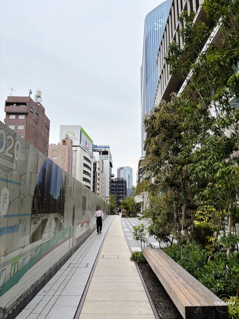 Takanawa LINK LINE outdoor promenade with railway rails