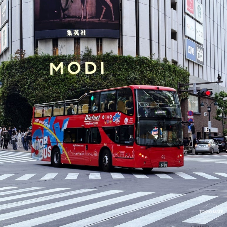 Tokyo SkyHop Bus departing from Marunouchi Mitsubishi Building, double-decker open-top hop-on hop-off
