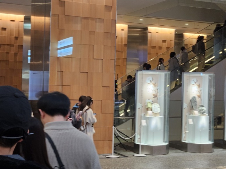 Riding escalator to 5th floor of KITTE