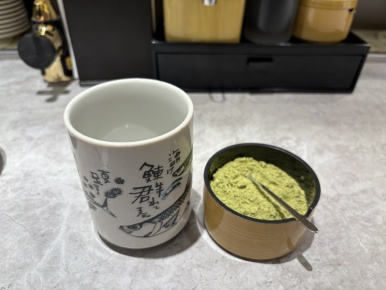 Making green tea from matcha powder at the seat