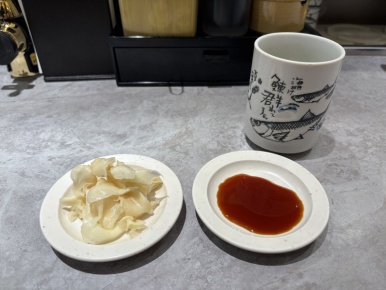 Green tea, soy sauce and pickled ginger setup at Nemuro Hanamaru
