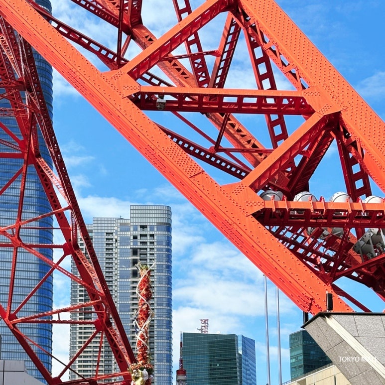 Looking straight up at Tokyo Tower's red steel structure from directly below