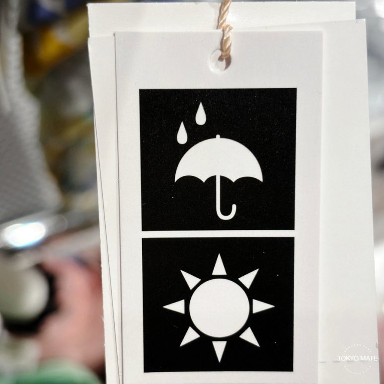 Wpc. umbrella tag showing the 晴雨兼用 and 自動開閉 markings